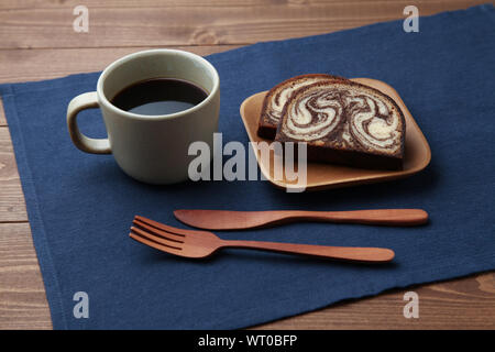 apple, black hot coffee and marble chocolate pound cake closeup isolated on wood table Stock Photo