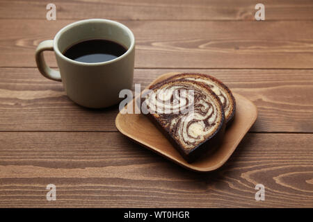 apple, black hot coffee and marble chocolate pound cake closeup isolated on wood table Stock Photo