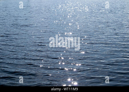 sun sparkling on water surface Stock Photo