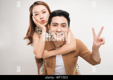Image of lovely couple having fun while man piggybacking his girlfriend Stock Photo