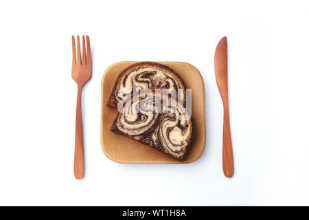 marble chocolate pound cake on wood plate with fork knife closeup isolated on white background Stock Photo