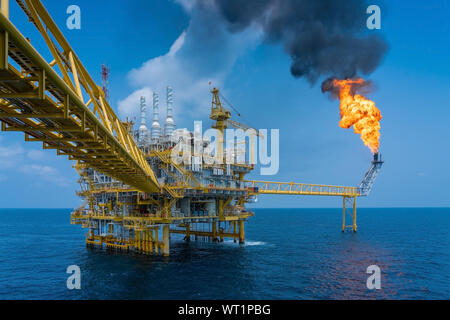 Offshore oil and gas construction platform while vent gases to flare platform to prevent over pressure from process upset, Power and energy business i Stock Photo