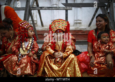 Kathmandu, Nepal. 11th Sep, 2019. Girls adorned as a Living Goddess take part in prayer rituals during Kumari Puja in Kathmandu. Hundreds of young girls under the age of nine gathered around the temple to offer worship for good luck, protection from evil and prevent from diseases. Credit: Skanda Gautam/ZUMA Wire/Alamy Live News Stock Photo