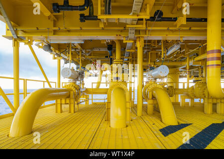 Offshore pipe, riser and sealine on oil and gas wellhead hub remote platform, the central facility to combine gases and crude together before set to c Stock Photo