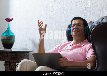 man listening music on his laptop Stock Photo