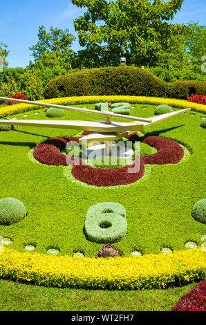 Popular Flower clock in Geneva, Switzerland. L'horloge fleurie in French, outdoor flower clock located on the western side of Jardin Anglais park. Symbol of the city's watchmakers, tourist attraction. Stock Photo