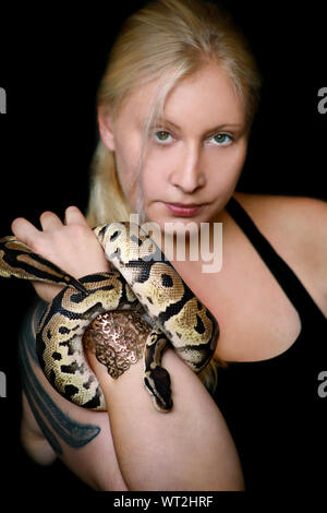 Python Girl Snake Portrait of girl with Royal Python snake. Woman holds Ball Python snake ...