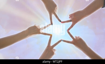 People forming star shape with their fingers against the backdrop of a pink magical sky with shining rays of the sun. Stock Photo