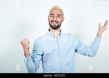 man with blond hair, black beard over isolated white background shows emotions Stock Photo