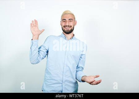 man with blond hair, black beard over isolated white background shows emotions Stock Photo