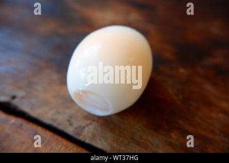 Shell boiled eggs, placed on a wooden floor Stock Photo
