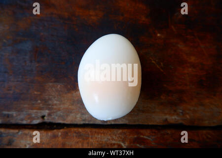 Shell boiled eggs, placed on a wooden floor Stock Photo