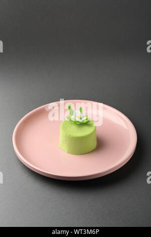 Green spring mini cake close-up on plate, dessert Stock Photo
