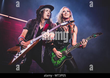 September 10th, 2019 - Guitarists Nita Strauss and Ryan Roxie performing live together with Alice Cooper at the Pala Alpitour in Torino. Stock Photo