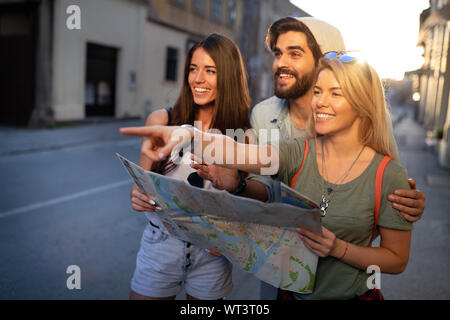 Young happy group of friends sightseeing in city Stock Photo