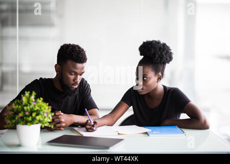 Image of two young businessmen interacting at meeting in office Stock Photo
