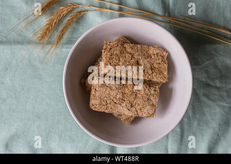 Cereal bars in breakfast bowl with wheat ears next to it - top view photo Stock Photo