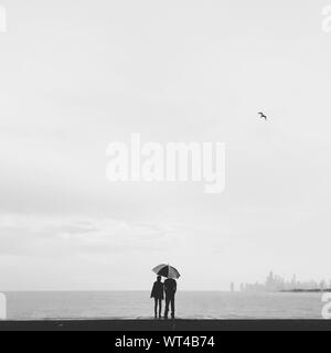 Silhouette Couple Under Umbrella At Montrose Harbor