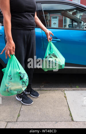 A woman carrying the new Aldi Supermarket compostable carriers bags ...