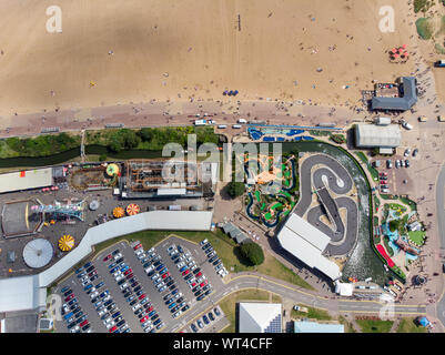 Aerial photo of the British seaside town of Skegness in the East Lindsey a district of Lincolnshire, England, showing the fairground funfair rides and Stock Photo