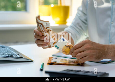 man counting euro cash money bills on the table Stock Photo