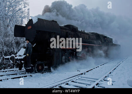 Bosnian worker prepare a steam engine for monthly service on steam powered locomotive classes 33 (originally DRB 52 ) built 1943 at coal mine central Stock Photo