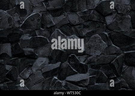 Black stone wall background. Mosaic of bricks in retro style, modern. Dark rock texture, brick wall pattern. Gray grunge surface. Marble geometric fac Stock Photo