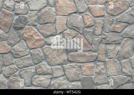 Beige, light brown stone texture in retro style. Brick wall background. Abstract pattern of rocks . Rough paper. Gray stones, textured surface of cobb Stock Photo