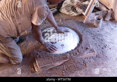 Manufacturing of aluminum kitchen utensils, working with salvaged materials, selective focus Stock Photo