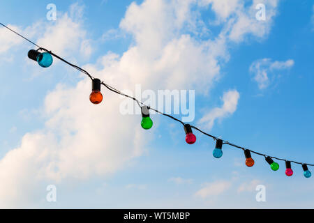 Colorfull lightbulbs against blue sky Stock Photo