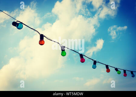 Colorfull lightbulbs against blue sky Stock Photo