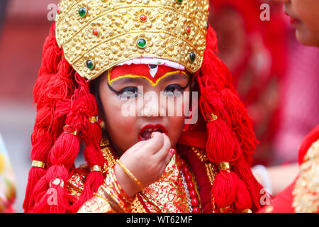 Kathmandu, Nepal. 11th Sep, 2019. A young girl dressed as the Living Goddess Kumari reacts during the rituals.Kumari puja is a tradition of worshipping young prepubescent girls as manifestations of the divine female energy. The ritual holds a strong religious significance in the Newar community that seeks divine blessings to save small girls from diseases and bad luck in the years to come. Credit: SOPA Images Limited/Alamy Live News Stock Photo