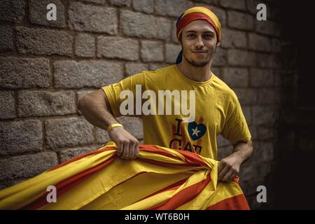 Barcelona, Spain. 11th Sep, 2019. A Pro-independence activist enrolls himself in a giant Catalan flag on Catalonia's national day, 'La Diada' Credit: Matthias Oesterle/Alamy Live News Stock Photo