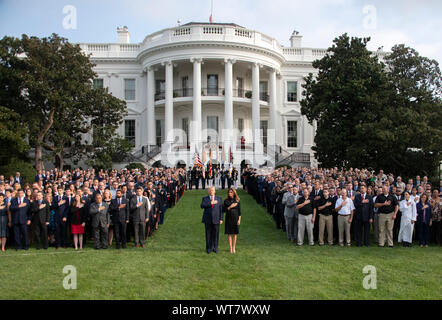 United States President Donald J. Trump and first lady Melania Trump observe a moment of silence at 8:46am EDT in commemoration of  the 18th anniversary of the terrorist attacks on the World Trade Center in New York, NY and the Pentagon in Washington, DC on Wednesday, September 11, 2019.Credit: Ron Sachs / CNP | usage worldwide Stock Photo