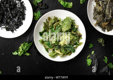 Dry seaweed, sea vegetables, close-up overhead shot on a black background