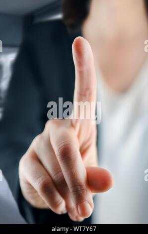 Businesswoman hand touching on virtual screen Stock Photo