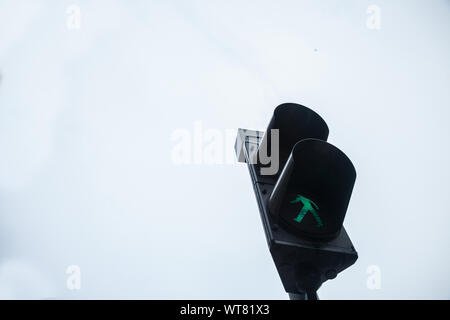 Pedestrian green light on a traffic light, abiding by the Serbian and European traffic regulations, letting walking people crossing a crosswalk and a Stock Photo