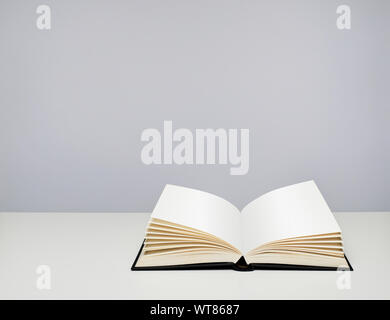 Open book. Hardback book with blank pages on a table Stock Photo