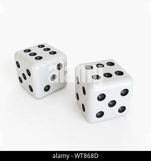 White dice, both showing six or a pair of sixes Stock Photo