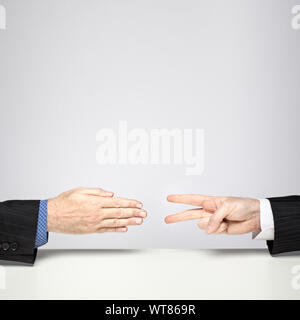 Two businessmen playing Rock, Paper, Scissors – Scissors beat Paper Stock Photo