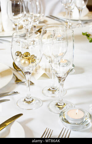 Wine glasses and champagne flute at a wedding table place setting Stock Photo