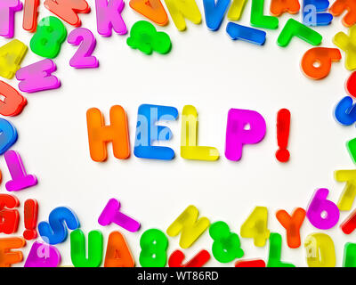 Help. Word. Plastic multi coloured fridge magnet alphabet spelling Help! Stock Photo