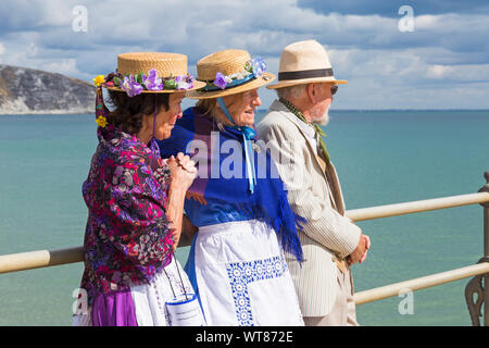 Clog dancers, members of the Beetlecrushers, standing on Swanage Pier at Swanage Folk Festival, Swanage, Dorset UK on a warm sunny day in September Stock Photo