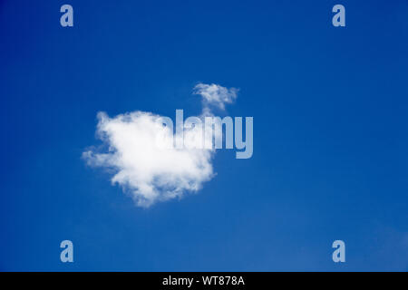 Blue sky and single solitary cloud Stock Photo