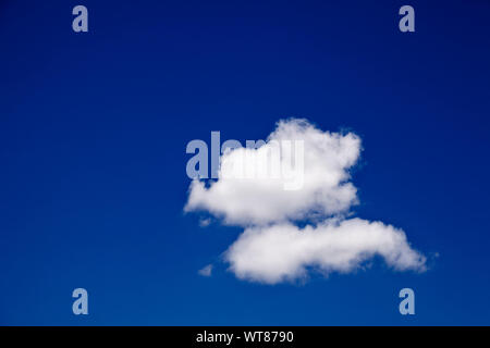 Blue sky and solitary cloud Stock Photo