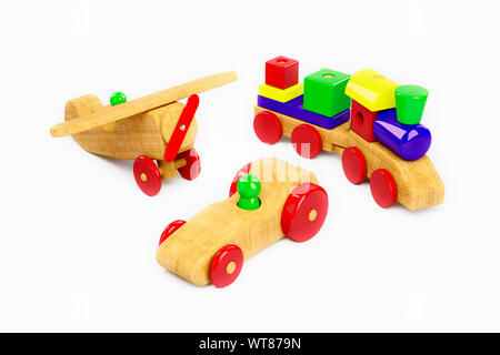 Wooden plane, train and racing car, a selection of childrens wooden toys on a white background Stock Photo