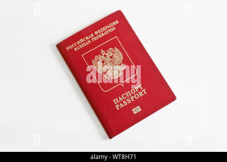 Russian foreign passport on a light gray background. Dark red passport cover. Stock Photo