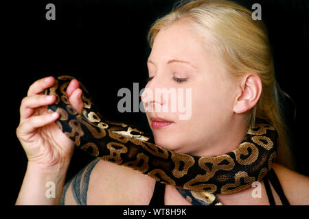 Woman with a snake around her neck Stock Photo - Alamy