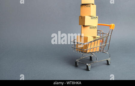 High tower of cardboard boxes on a supermarket trolley. concept of shopping in store. E-commerce, sales and sale of goods through online trading platf Stock Photo