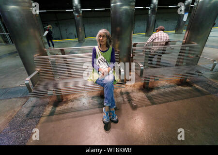 Woman waiting on the Blue Line subway platform, Maverick Square, East Boston, Massachusetts USA Stock Photo